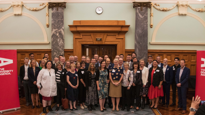 Diversity Agenda large group photo indoors with everyone looking at the camera