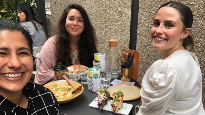 three women at lunch table taking a selfie