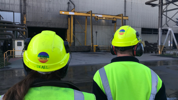 New Zealand Steel - two workers looking at something outdoors 