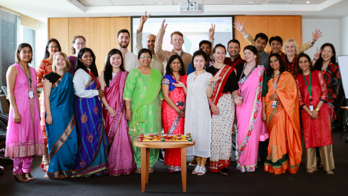 HSBC New Zealand group photo evryone smiling at the camera with everyone wearing their own traditional clothing 