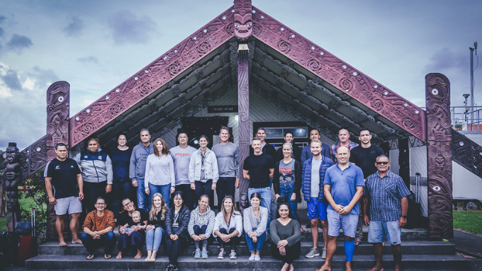 New Zealand Trade and Enterprise large group of people standing outside a marae all smiling at the camera