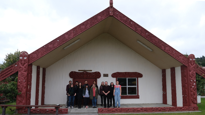 Springload group photo outside in front of a marae
