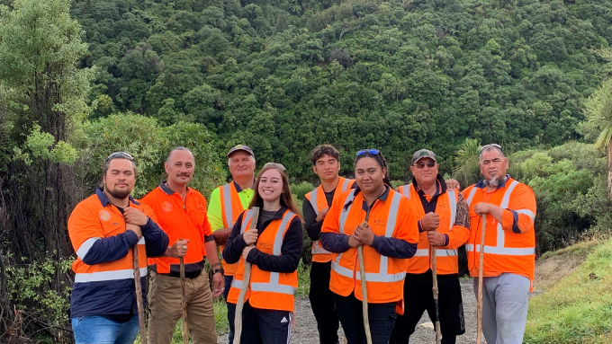 Te Ahu a Turanga_ Manawatū Tararua Highway Alliance group photo outdoors all smiling at the camera wearing hivis