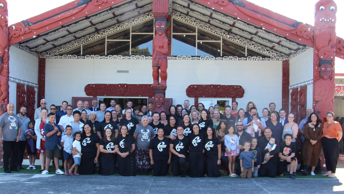 A large group of Air New Zealand staff in front of a marae A large group of Air New Zealand staff in front of a marae