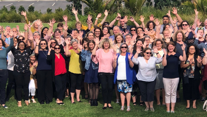 big group photo with everyone smiling at the camera with their hands in the air outdoors big group photo with everyone smiling at the camera with their hands in the air outdoors