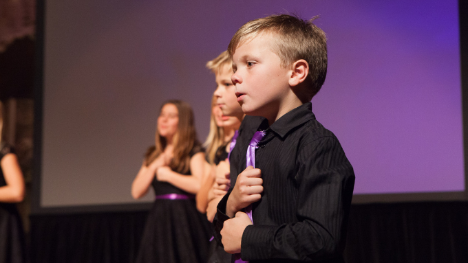 kids on stage communicating in sign language 