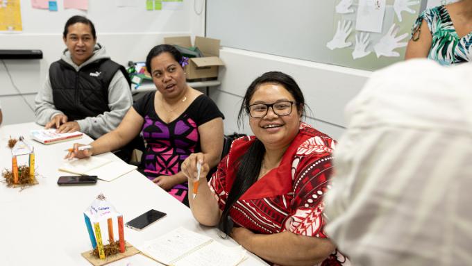 Three Pacific women participating in a discussion around the table