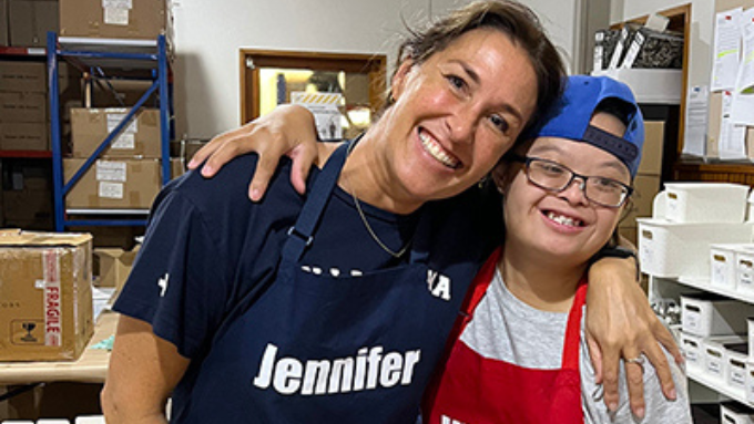 Managing Director, Jennifer Del Bel hugging and smiling with one of the Downlight crew