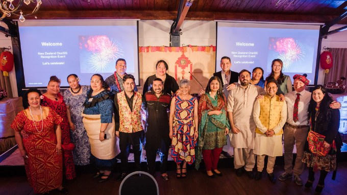 Group photo of ISS Facility Services's team indoors all smiling at the camera in traditional clothing 