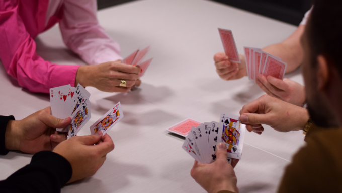 A photo of four people playing poker