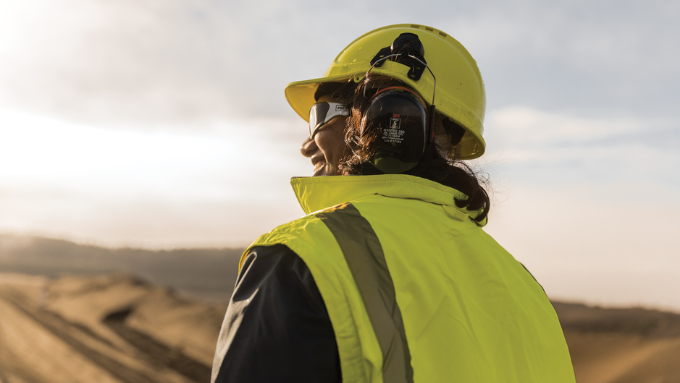 photo of a NZ steel worker outside in the sun smiling looking away from the camera photo of a NZ steel worker outside in the sun smiling looking away from the camera