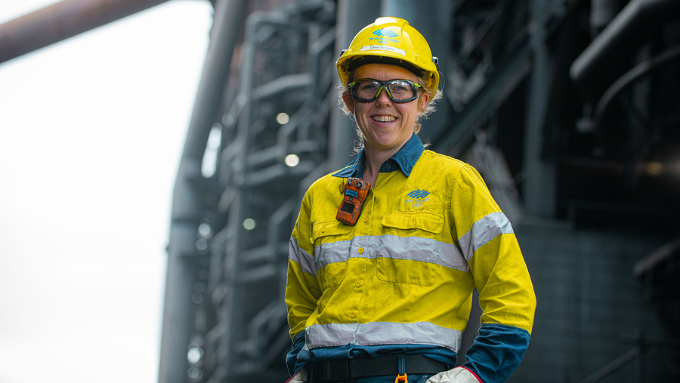 New Zealand Steel worker looking at the camera smiling in PPE outdoors