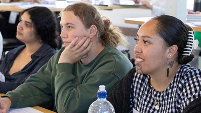 three women listening to a speaker