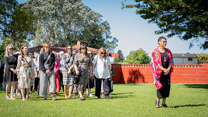 A woman leading the way to the marae during the traditional ceremony