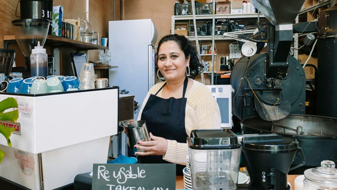 Woman making coffee in a cafe Woman making coffee in a cafe