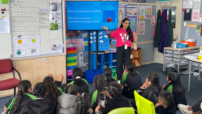 A Jacobs employee talking to children in a classroom about their job and engineering A Jacobs employee talking to children in a classroom about their job and engineering