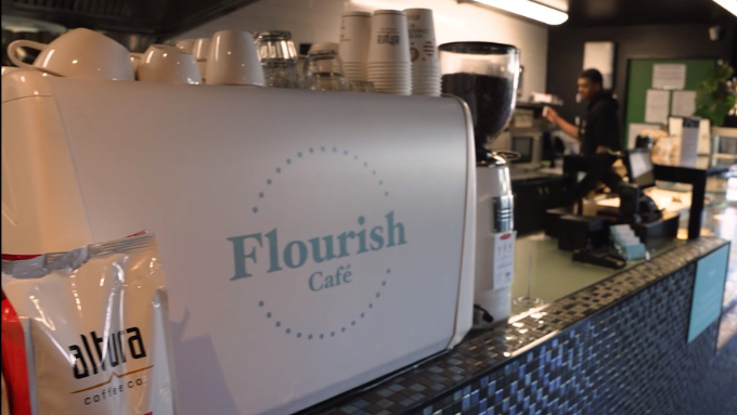 photo of a coffee machine in a cafe with barista in the back making coffee photo of a coffee machine in a cafe with barista in the back making coffee