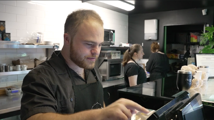 barista taking an order on the terminal system 