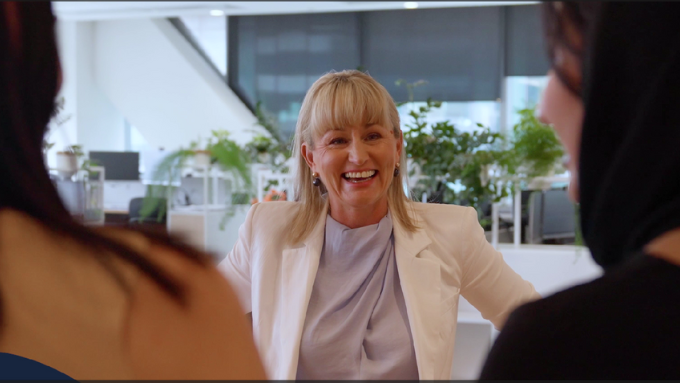 women smiling talking to co workers in a meeting women smiling talking to co workers in a meeting