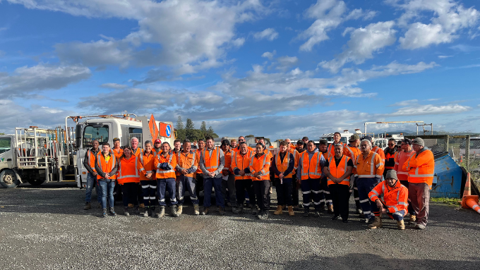 20 Ventia co workers in high vis vests standing in front of their work trucks smiling at the camera 20 Ventia co workers in high vis vests standing in front of their work trucks smiling at the camera