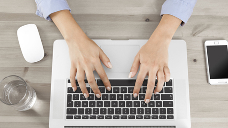 Woman's hands typing on laptop keyboard Woman's hands typing on laptop keyboard